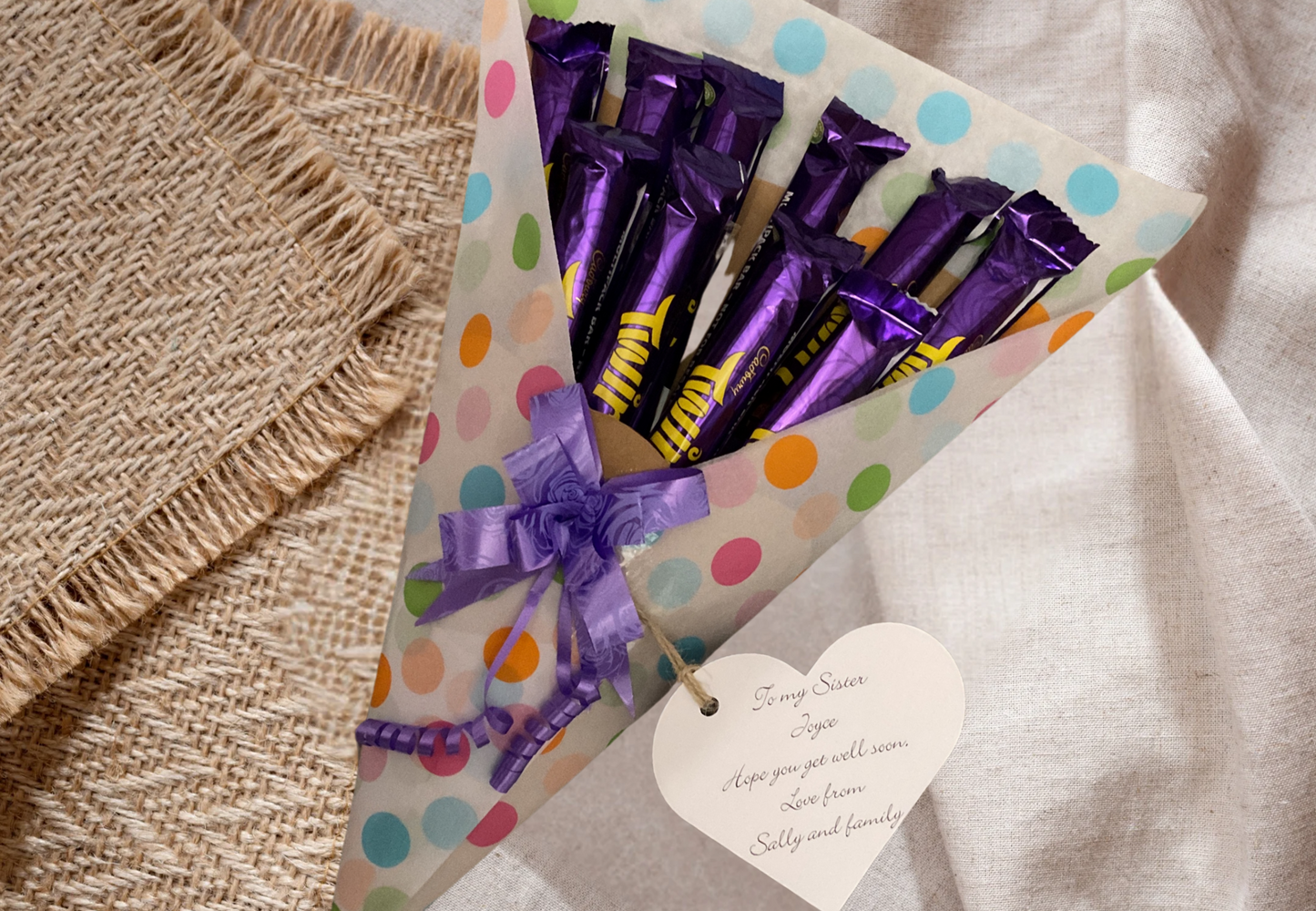 Cadbury twirl chocolate bouquet with a personalised tag and matching bow.
